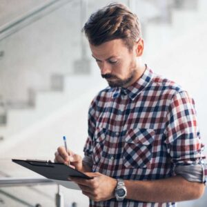 Homeowner reviewing a checklist while choosing a real estate agent.