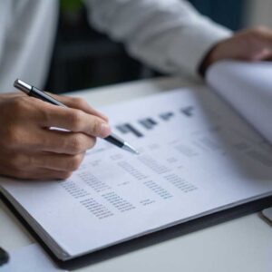 Close-up of a real estate marketing audit document with charts and notes on a desk