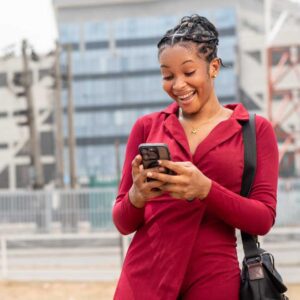 Homeowner smiling while checking her phone after receiving a Richmond home value estimate by text