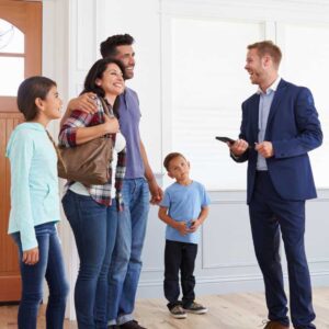 Hampton Roads real estate agent hosting an open house and speaking with a family inside the home